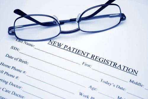 New Patient Registration form with eye glasses on top of form